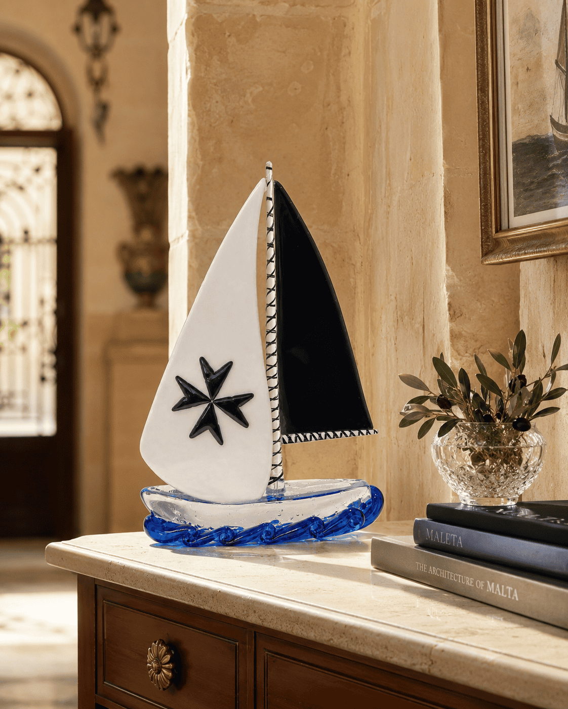 Hand-blown Maltese glass sailboat, crafted by artisans in Malta, showcasing traditional glassmaking.